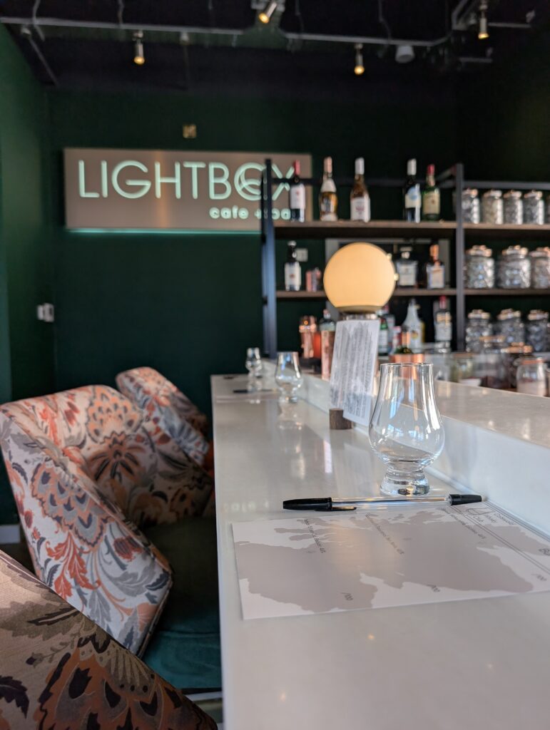 Glencairn glasses displayed on a bar wth Cotswold Whisky Club branded tasting sheets